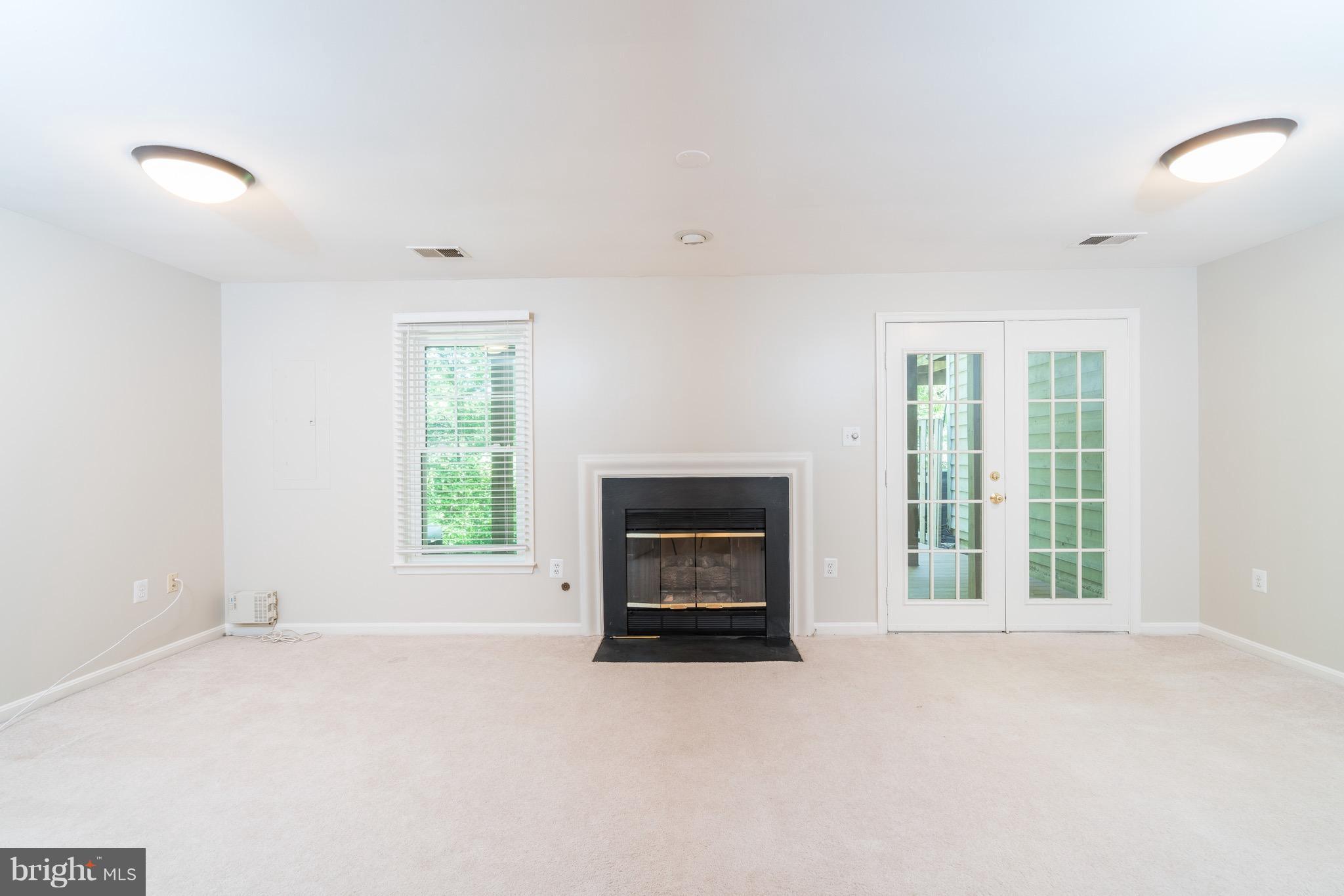 1211 Weatherstone Court Reston, VA 20194 - Photo 23 of 30 an empty room with a fireplace and window