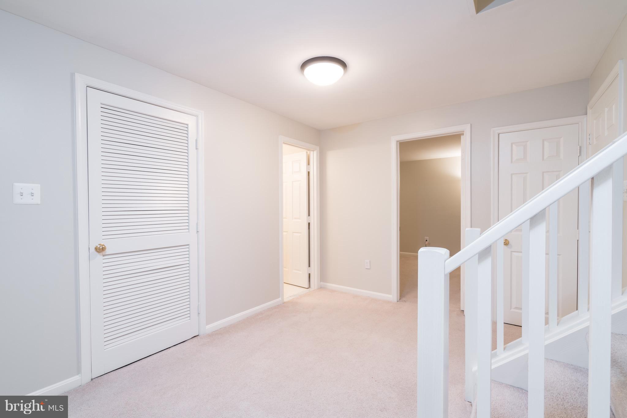 1211 Weatherstone Court Reston, VA 20194 - Photo 24 of 30 a view of an empty room with stairs and a window