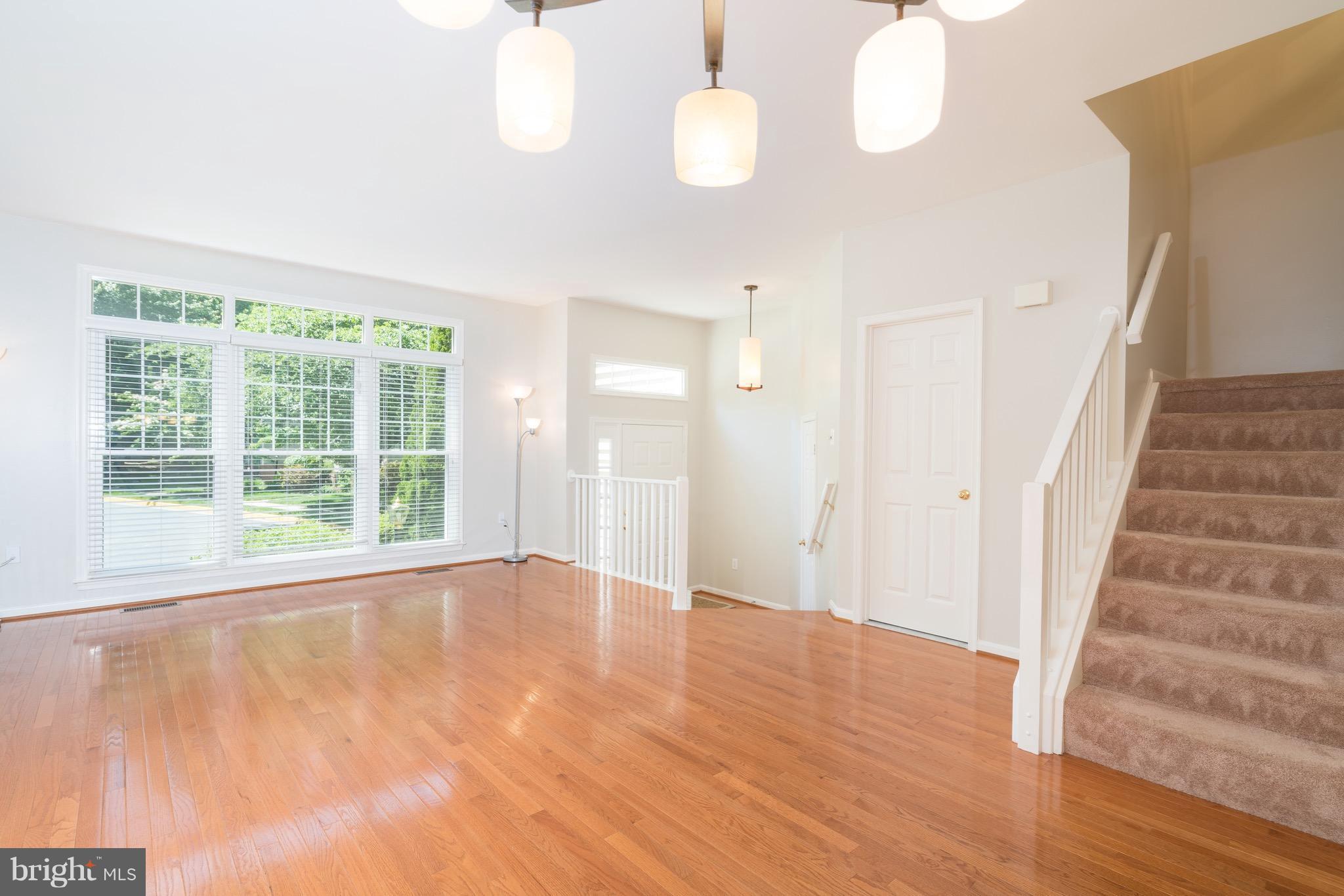 1211 Weatherstone Court Reston, VA 20194 - Photo 5 of 30 a view of an empty room with wooden floor and a window