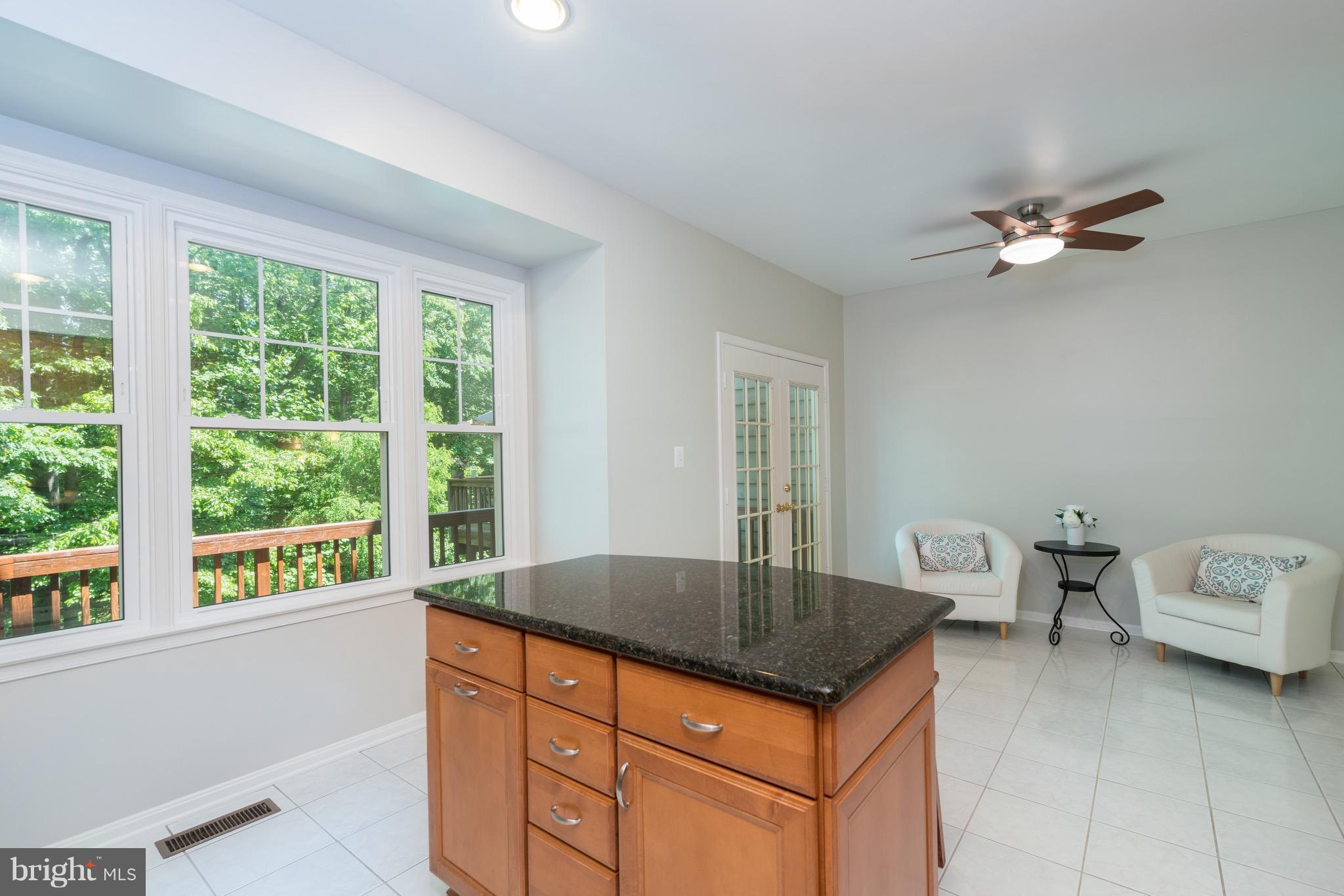 1211 Weatherstone Court Reston, VA 20194 - Photo 10 of 30 a kitchen with granite countertop a sink a counter top space and living room area