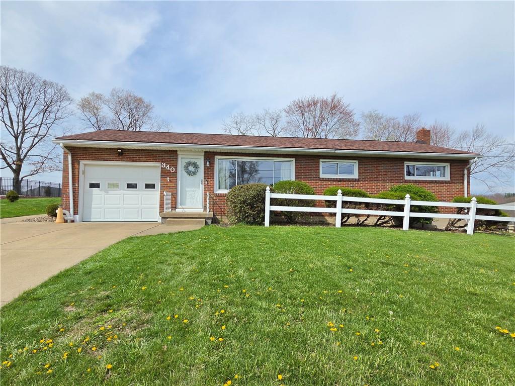 a front view of a house with a yard and a garage