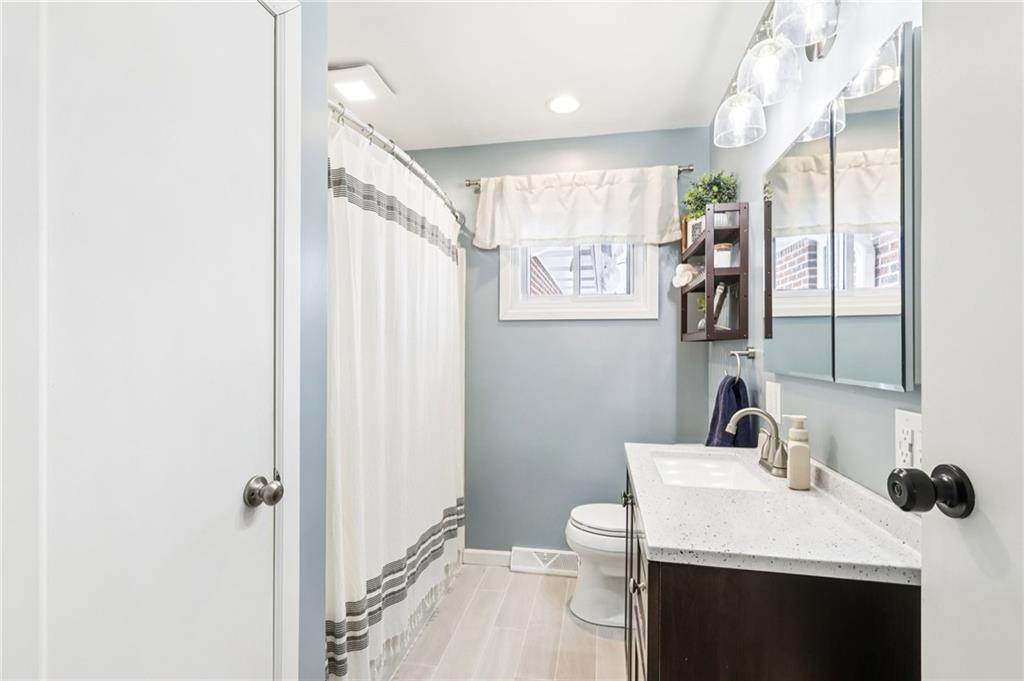340 Westbrook Drive Butler, PA 16001 - Photo 18 of 25 a bathroom with a sink a toilet a mirror and shower