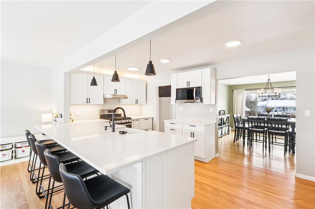 340 Westbrook Drive Butler, PA 16001 - Photo 6 of 25 a kitchen with stainless steel appliances a dining table chairs stove and white cabinets