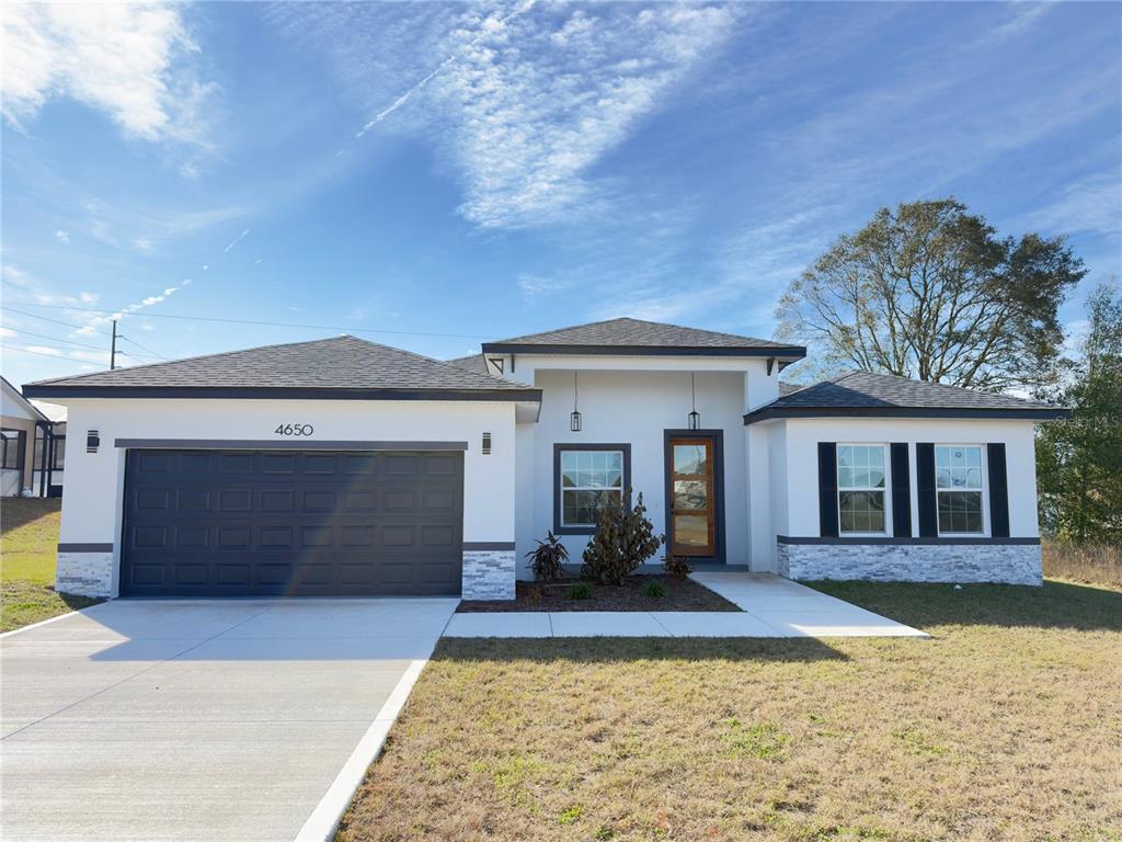 4650 Southwest 139th Place Ocala, FL 34473 - Photo 1 of 49 a front view of a house with garden