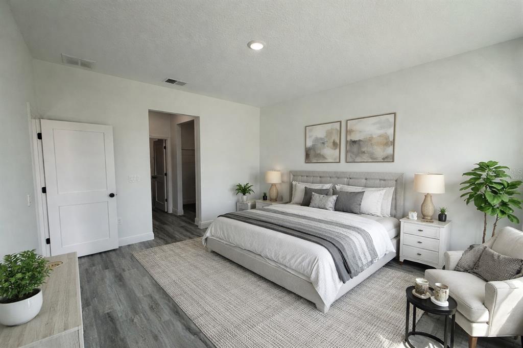 4650 Southwest 139th Place Ocala, FL 34473 - Photo 11 of 49 a spacious bedroom with a bed and a couch