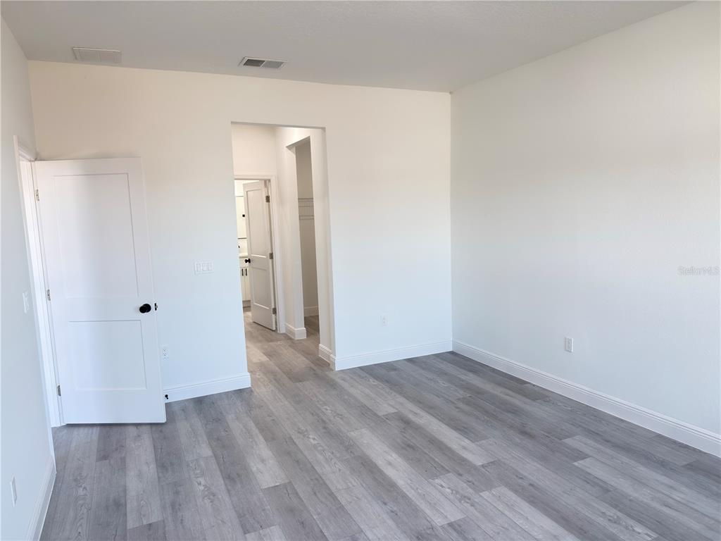 4650 Southwest 139th Place Ocala, FL 34473 - Photo 13 of 49 an empty room with wooden floor and closet