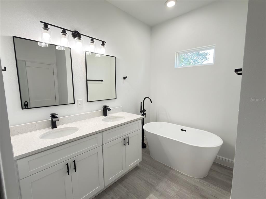 4650 Southwest 139th Place Ocala, FL 34473 - Photo 16 of 49 a bathroom with a bathtub and a sink