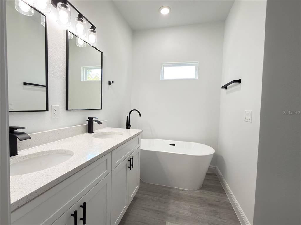 4650 Southwest 139th Place Ocala, FL 34473 - Photo 17 of 49 a bathroom with a white sink a toilet and a mirror