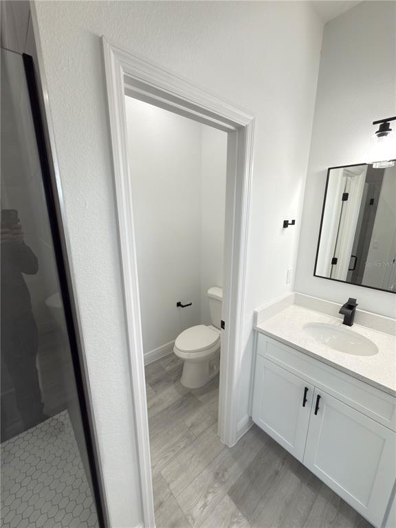 4650 Southwest 139th Place Ocala, FL 34473 - Photo 19 of 49 a bathroom with a granite countertop sink toilet and shower a mirror