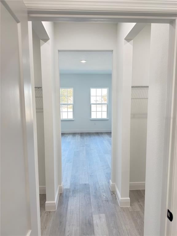 4650 Southwest 139th Place Ocala, FL 34473 - Photo 21 of 49 a view of an empty room with wooden floor and a window