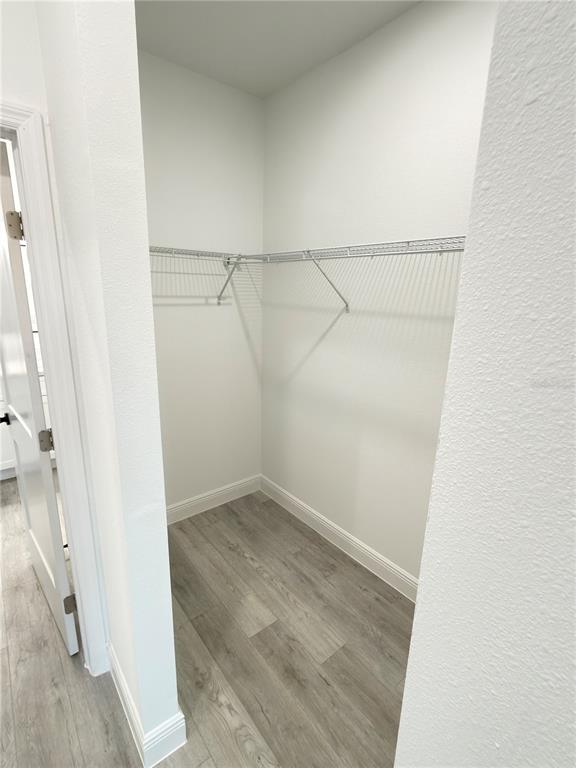 4650 Southwest 139th Place Ocala, FL 34473 - Photo 23 of 49 a view of an empty walk in closet with wooden floor