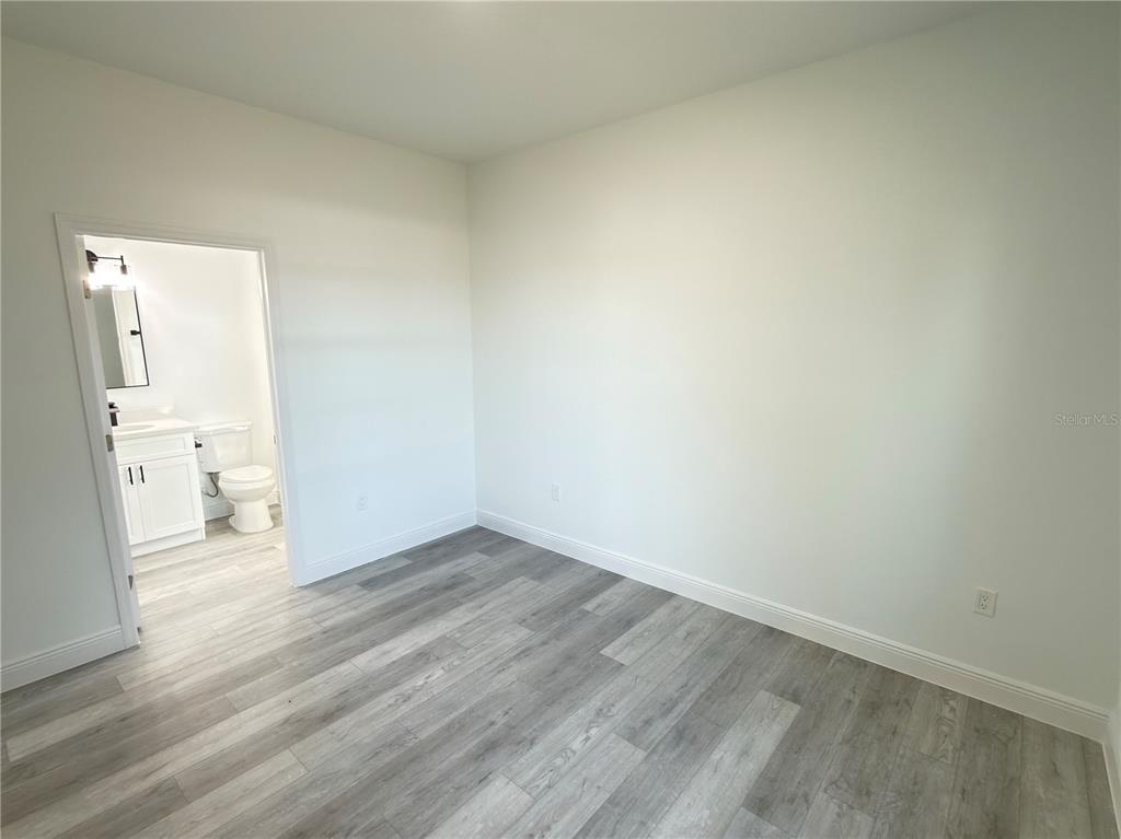 4650 Southwest 139th Place Ocala, FL 34473 - Photo 28 of 49 a view of a room with wooden floor and a toilet