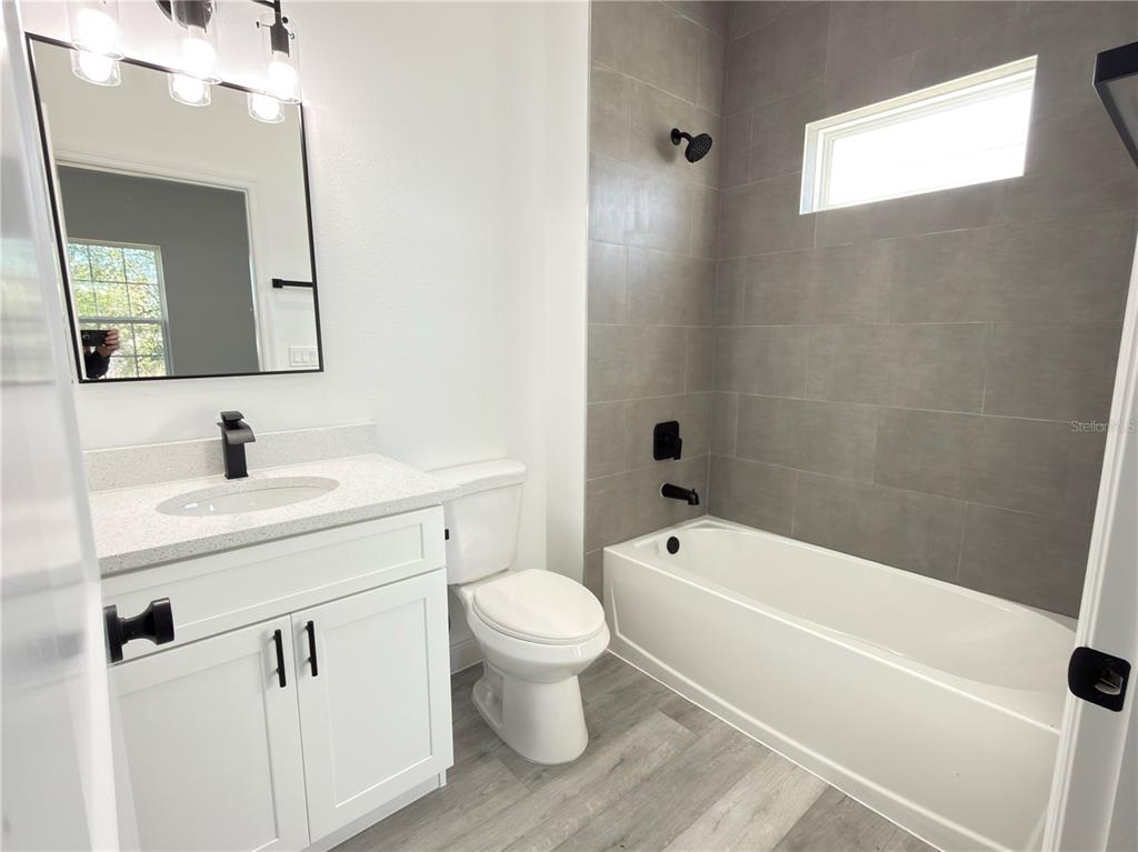 4650 Southwest 139th Place Ocala, FL 34473 - Photo 30 of 49 a bathroom with a toilet sink vanity tub and mirror