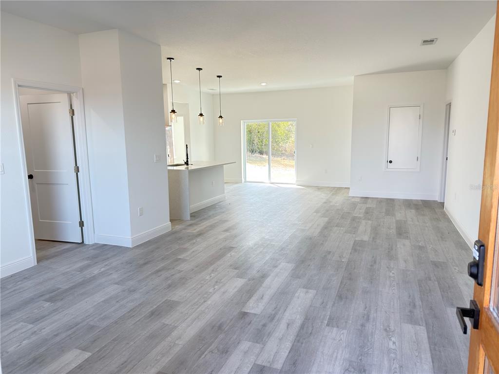 4650 Southwest 139th Place Ocala, FL 34473 - Photo 3 of 49 a view of empty room with wooden floor and window