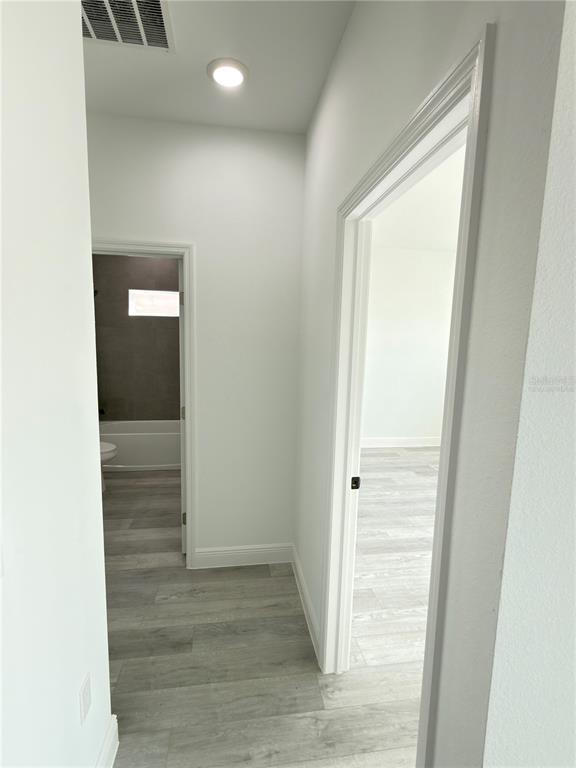 4650 Southwest 139th Place Ocala, FL 34473 - Photo 31 of 49 a view of a hallway with wooden floor
