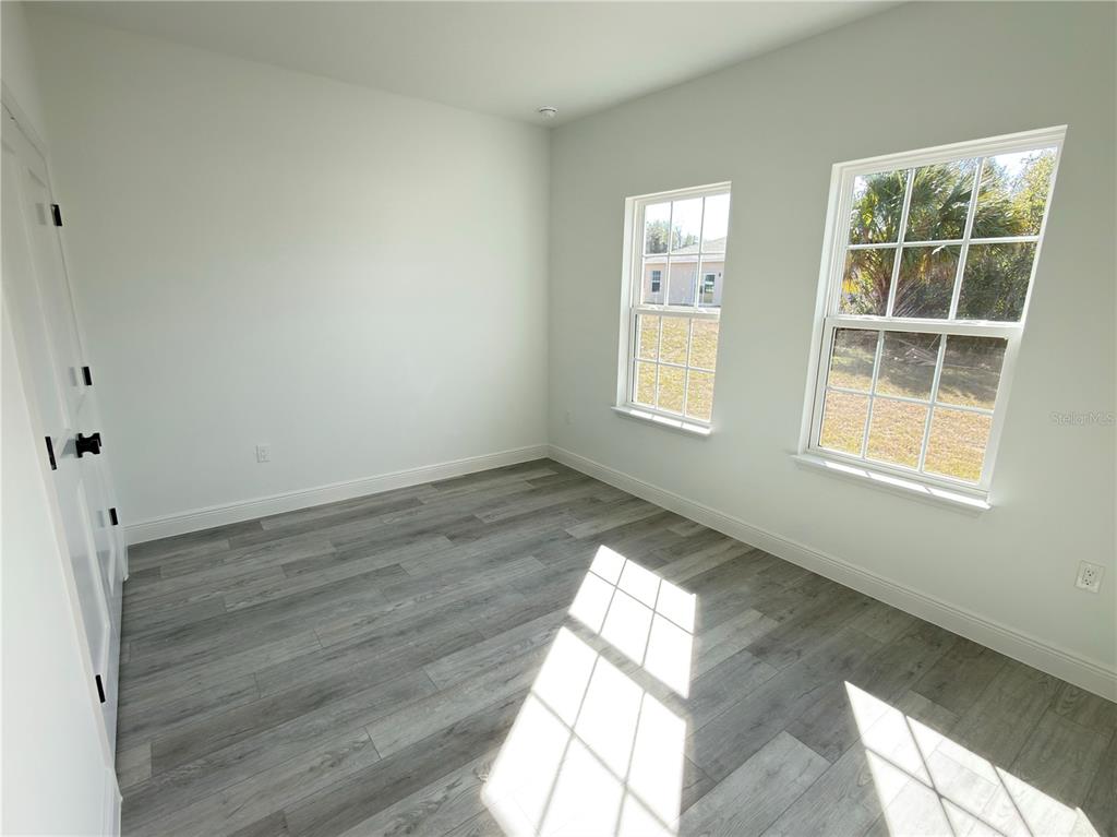 4650 Southwest 139th Place Ocala, FL 34473 - Photo 33 of 49 an empty room with wooden floor and windows