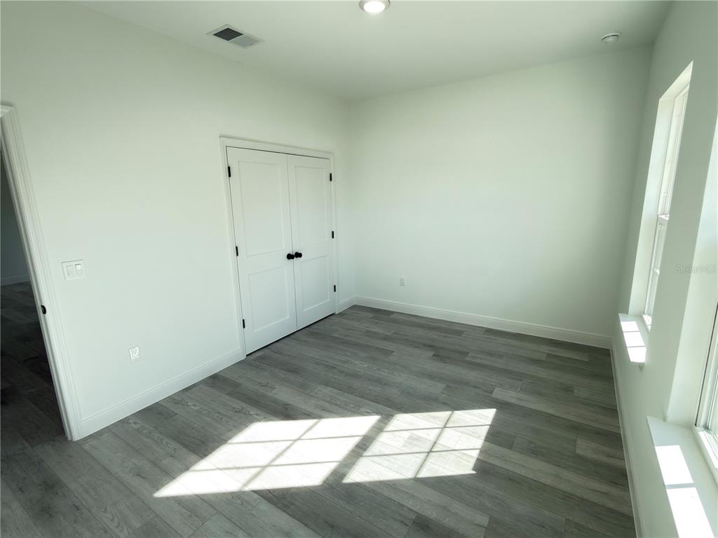 4650 Southwest 139th Place Ocala, FL 34473 - Photo 34 of 49 an empty room with wooden floor