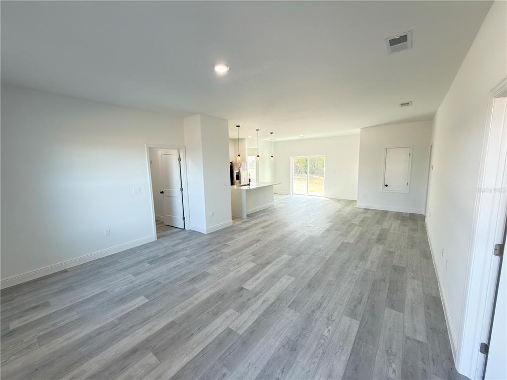 4650 Southwest 139th Place Ocala, FL 34473 - Photo 4 of 49 wooden floor in an empty room with wooden floor
