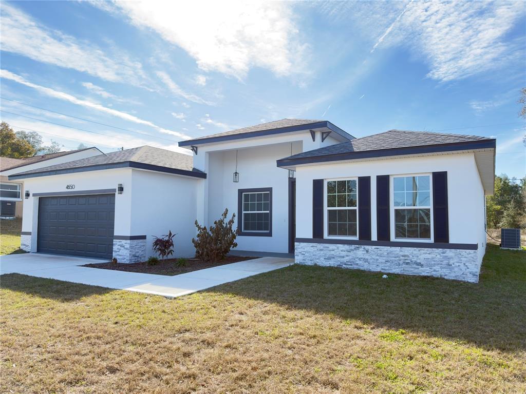 4650 Southwest 139th Place Ocala, FL 34473 - Photo 43 of 49 a view of a house with swimming pool in front of it