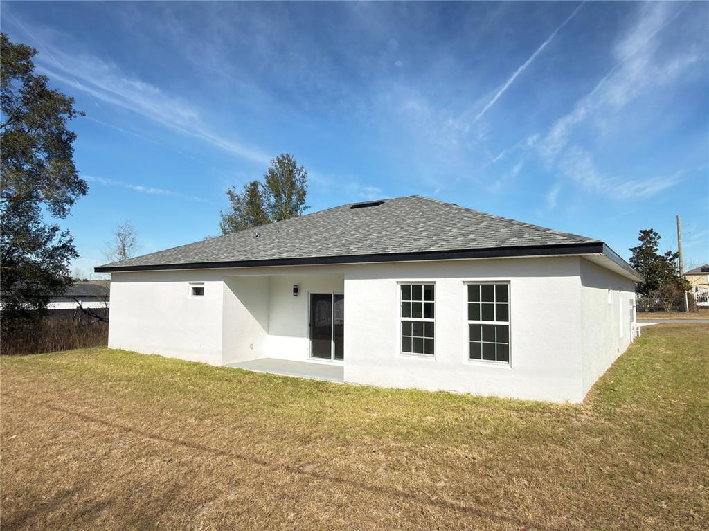 4650 Southwest 139th Place Ocala, FL 34473 - Photo 47 of 49 a front view of a house with a yard and garage