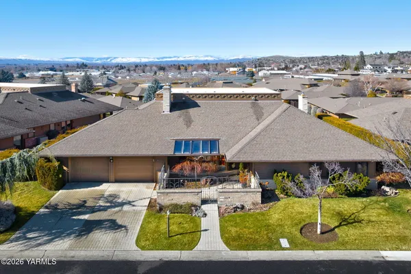 an aerial view of a house with a yard swimming pool and outdoor seating