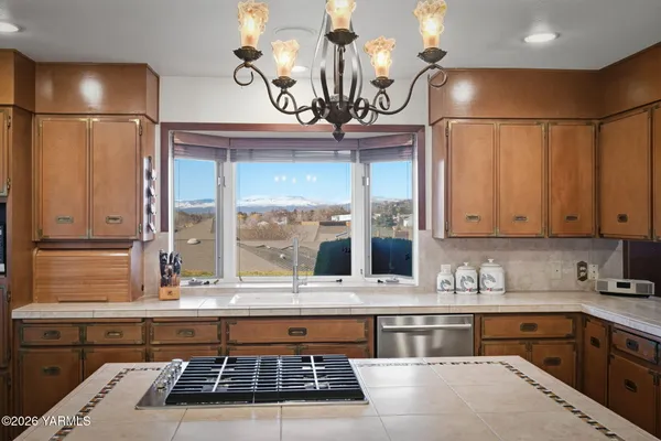 a front view of house with yard and trees in the background