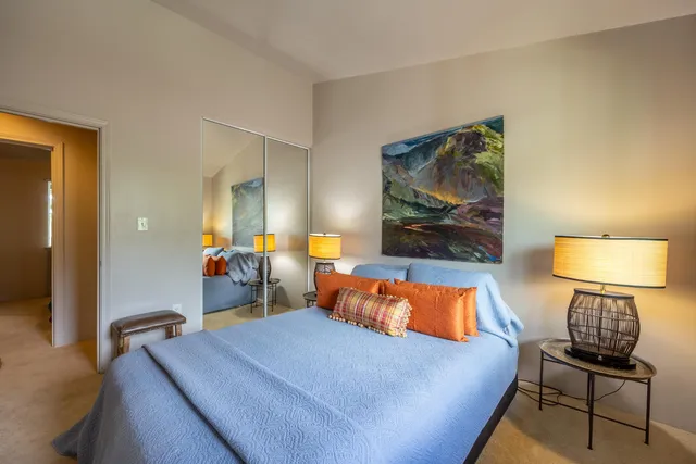 a bed room with a bed and a chair