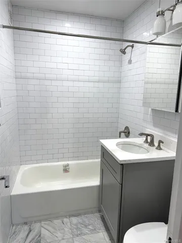 a bathroom with a sink mirror toilet and bathtub