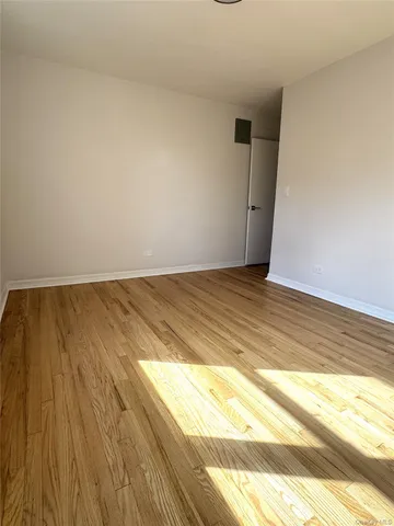 a view of room with wooden floor