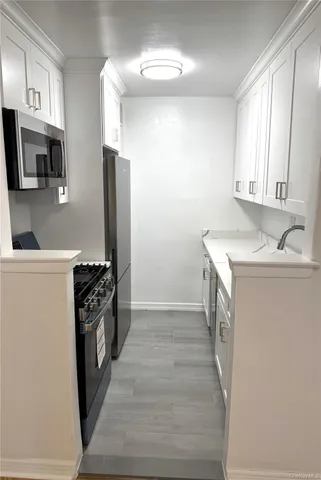 a kitchen with granite countertop a refrigerator and a stove