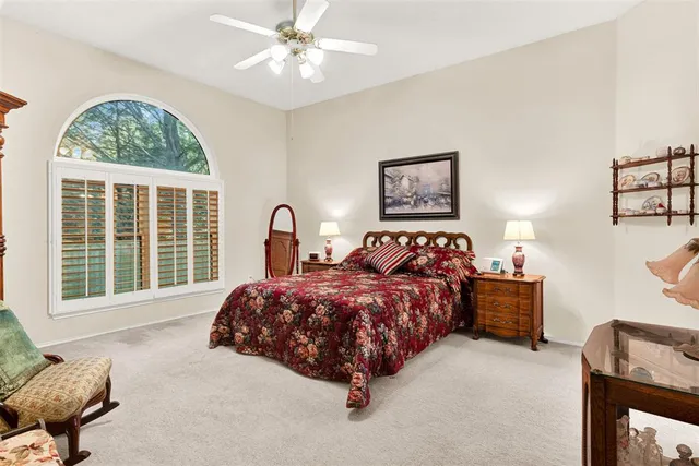 a bed sitting in a bedroom next to a window