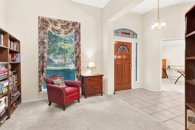 a bedroom with furniture and a book shelf