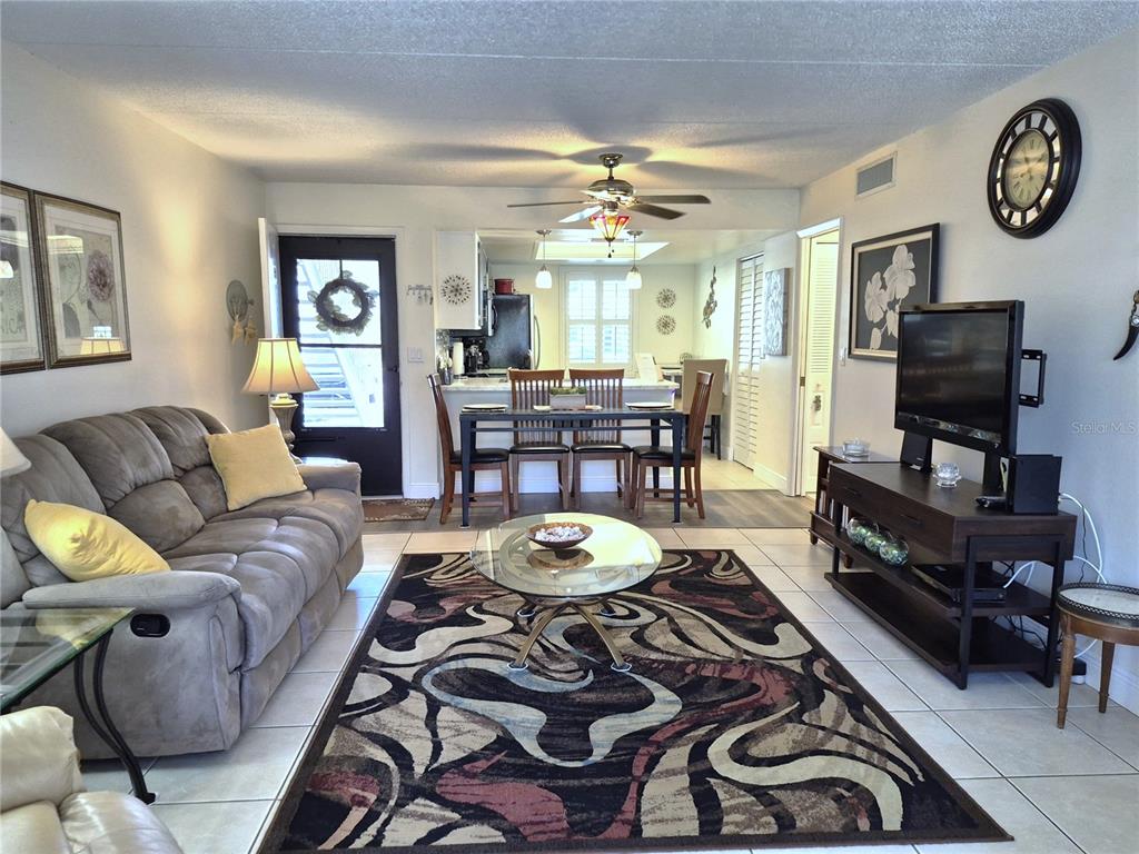 107 Windward Place, Unit 107 Oldsmar, FL 34677 - Photo 7 of 34 a living room with furniture a clock on wall and a window