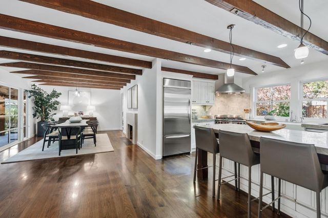 a kitchen with stainless steel appliances granite countertop a stove and a sink