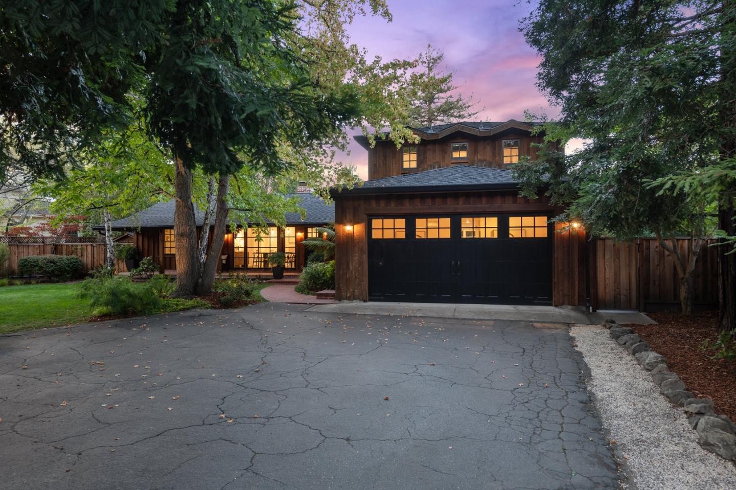 1275 Cañada Road Woodside, CA 94062 - Photo 3 of 62 a front view of a house with a yard and garage