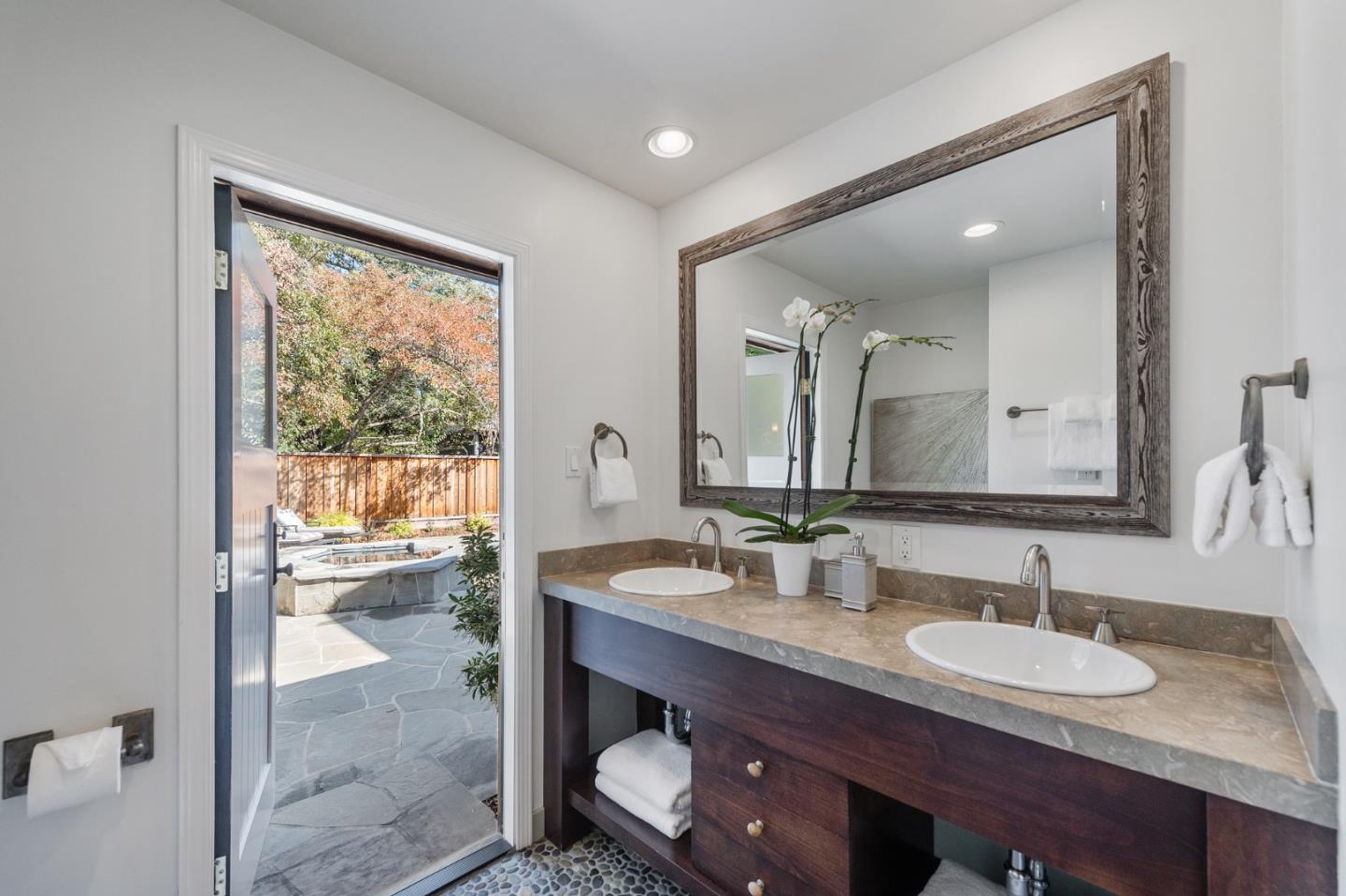 1275 Cañada Road Woodside, CA 94062 - Photo 33 of 62 a bathroom with a granite countertop sink a mirror and a shower