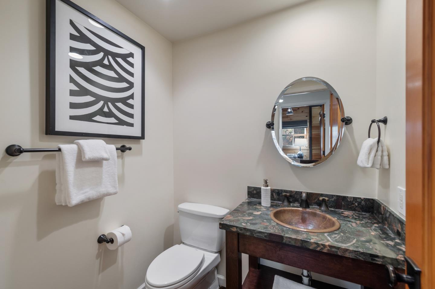1275 Cañada Road Woodside, CA 94062 - Photo 38 of 62 a bathroom with a toilet a sink and a mirror