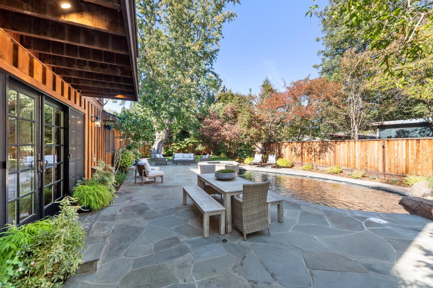 1275 Cañada Road Woodside, CA 94062 - Photo 42 of 62 a view of a patio with a table and chairs and potted plants