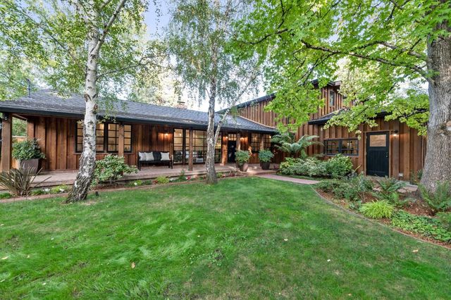 a view of a house with a yard patio and a garden