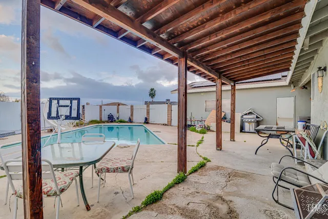 a view of a patio with table and chairs