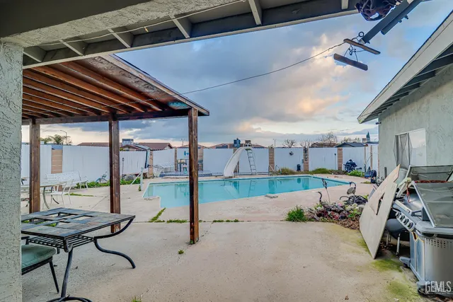 a view of a patio with table and chairs