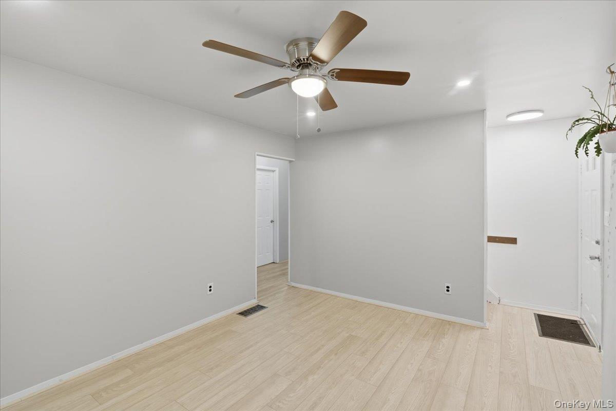 30 George Drive Mastic, NY 11950 - Photo 14 of 26 wooden floor in an empty room