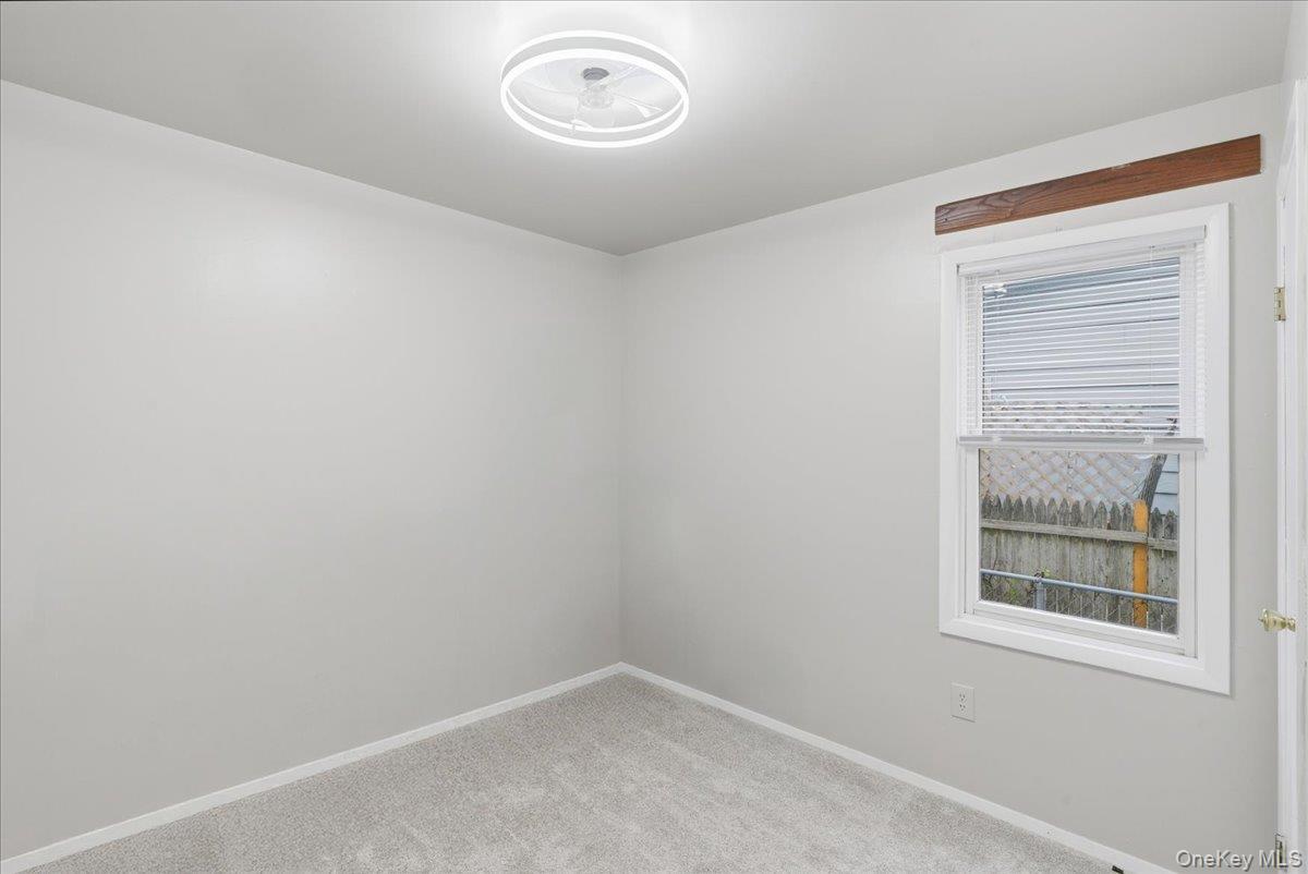 30 George Drive Mastic, NY 11950 - Photo 15 of 26 an empty room with windows
