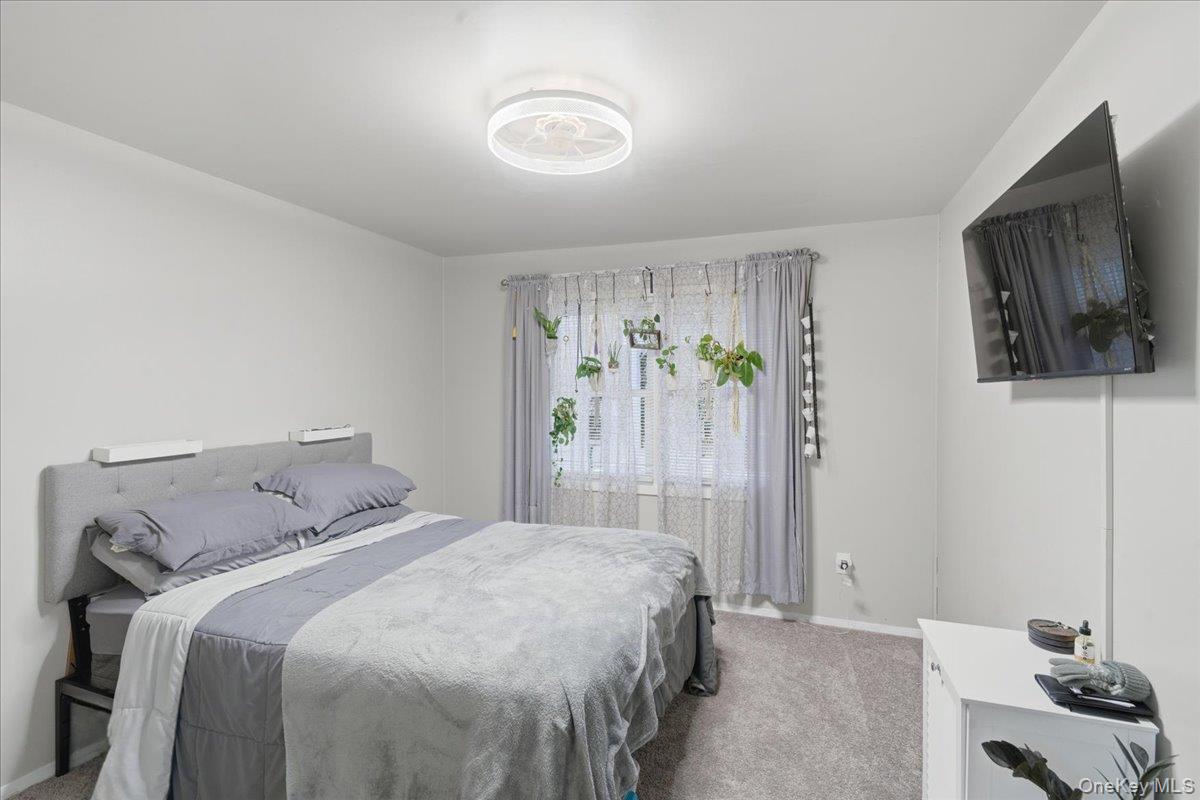 30 George Drive Mastic, NY 11950 - Photo 16 of 26 a bedroom with a bed and a window