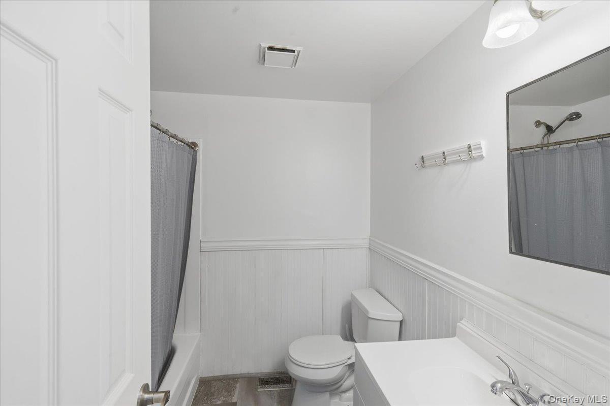 30 George Drive Mastic, NY 11950 - Photo 20 of 26 a white toilet sitting next to a shower
