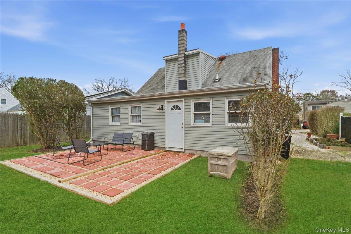 30 George Drive Mastic, NY 11950 - Photo 21 of 26 a front view of a house with garden