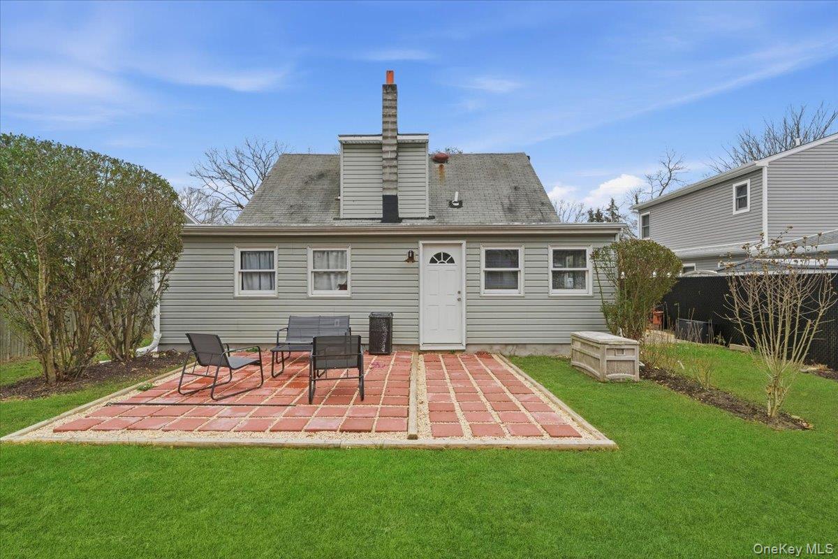 30 George Drive Mastic, NY 11950 - Photo 22 of 26 a view of a house with a backyard