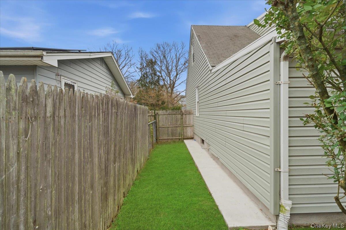30 George Drive Mastic, NY 11950 - Photo 25 of 26 a view of a backyard with pathway