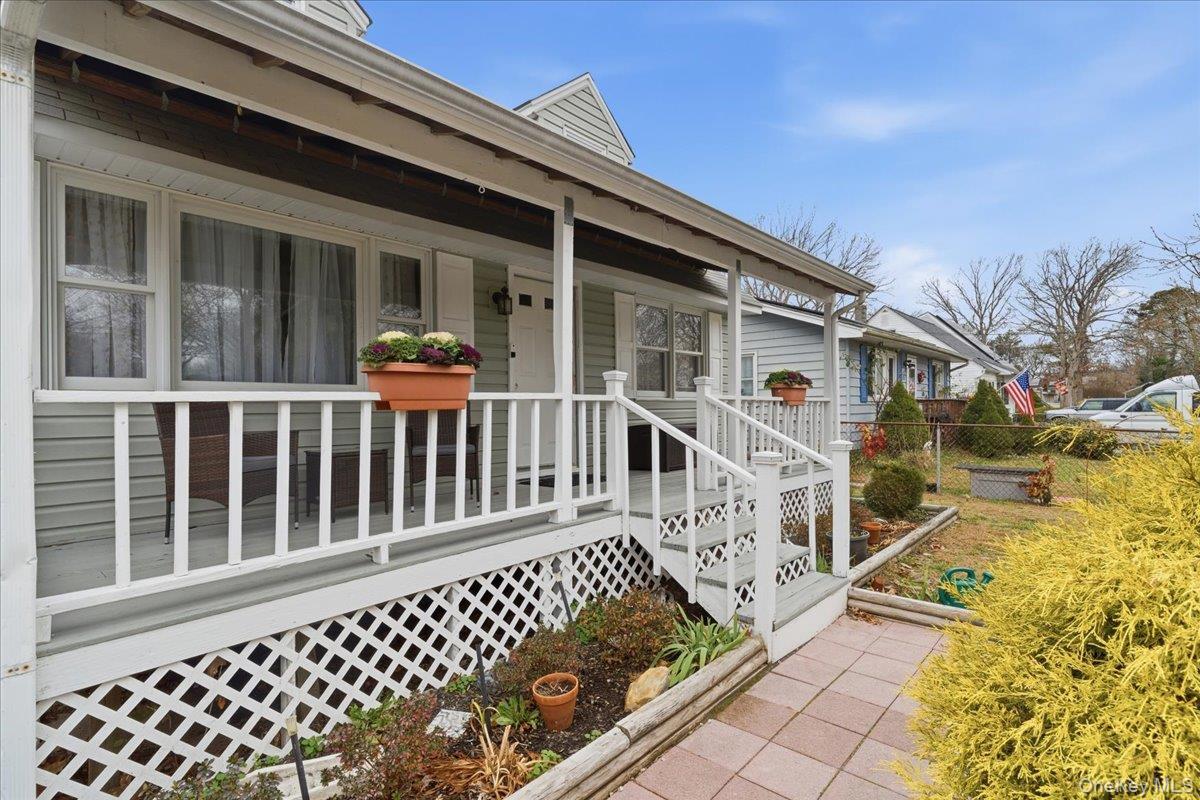 30 George Drive Mastic, NY 11950 - Photo 4 of 26 a view of a house with wooden fence