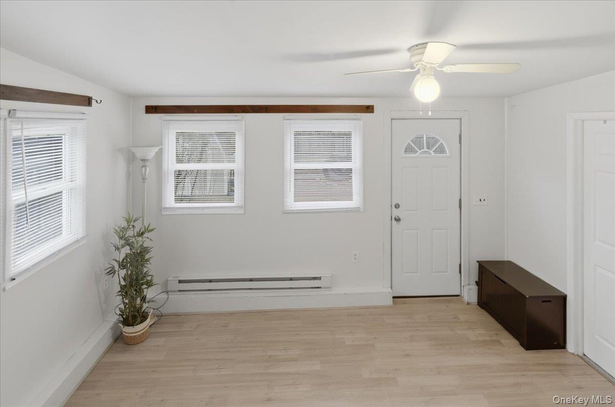 30 George Drive Mastic, NY 11950 - Photo 7 of 26 an empty room with windows and ceiling fan